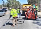 A Georgia DOT crew seals pavement on a Fayette road in a 2014 file photo.